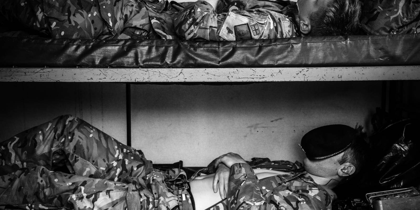 Image shows two soldiers resting