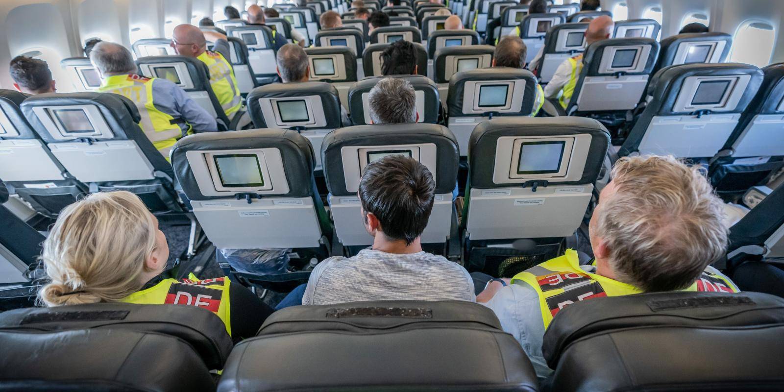 Police officers escort rejected Afghan asylum seekers aboard an aircraft heading to Kabul, on 1 August 2019 at an airport in Leipzig, Germany.