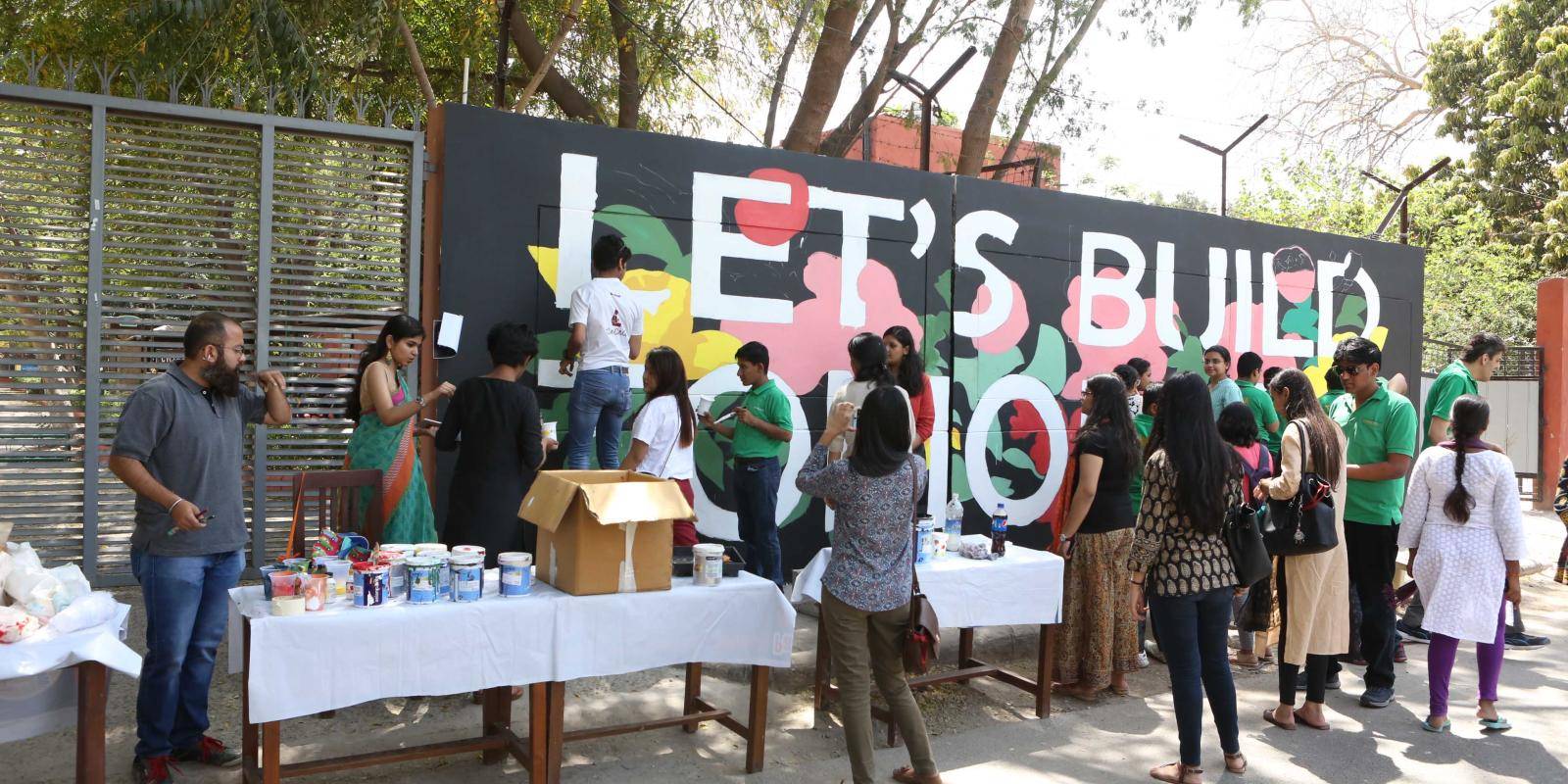 At a street art event in New Delhi, the phrase Let's Build Tomorrow is painted on a wall
