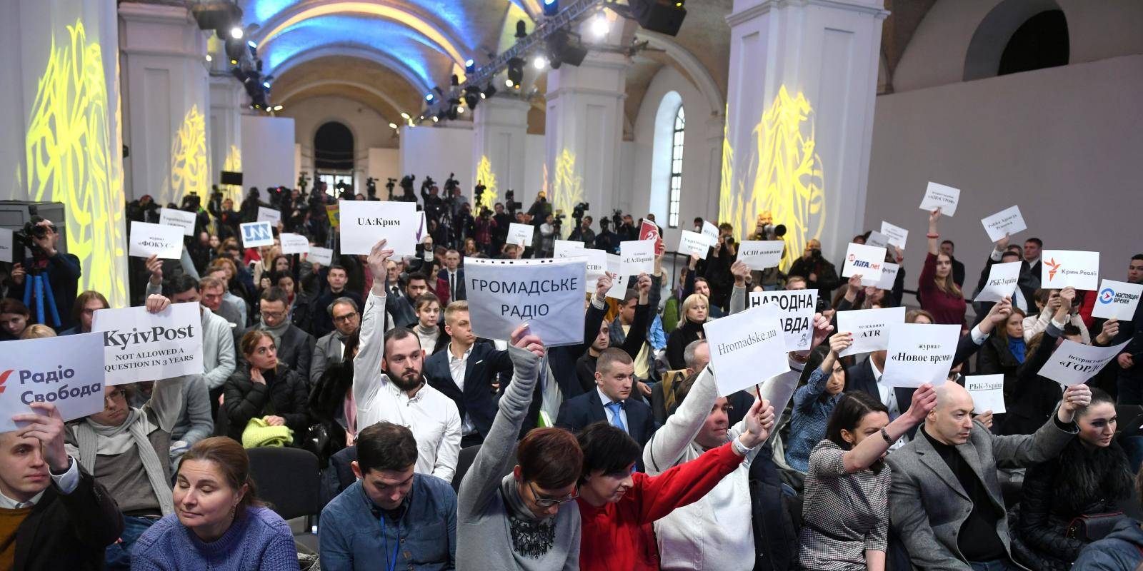Ukrainian journalists wait to ask questions at a press conference.