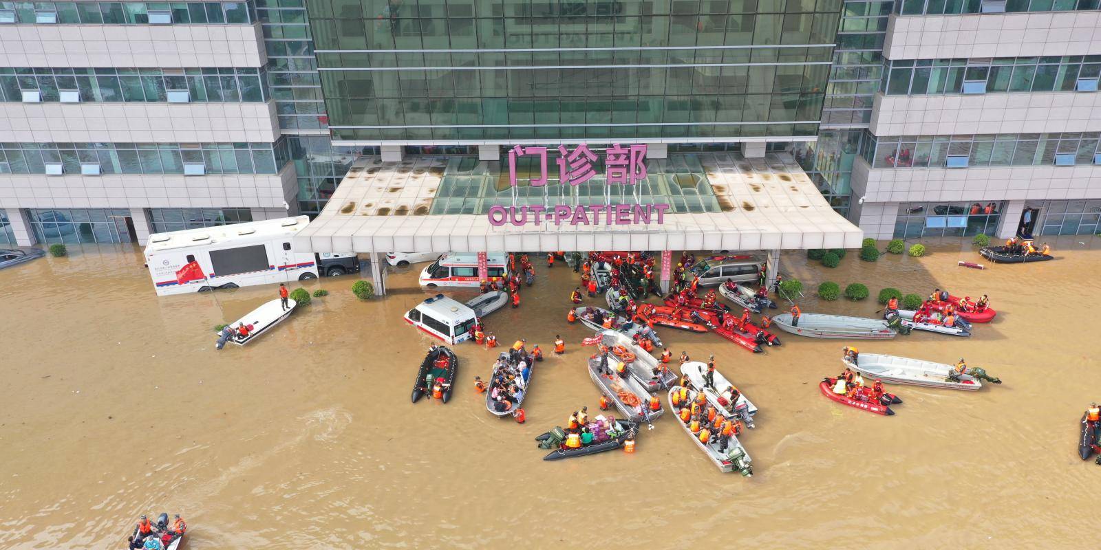 Photo shows rescue workers in boats working to evacuate a flooded hospital in Zhengzhou, China