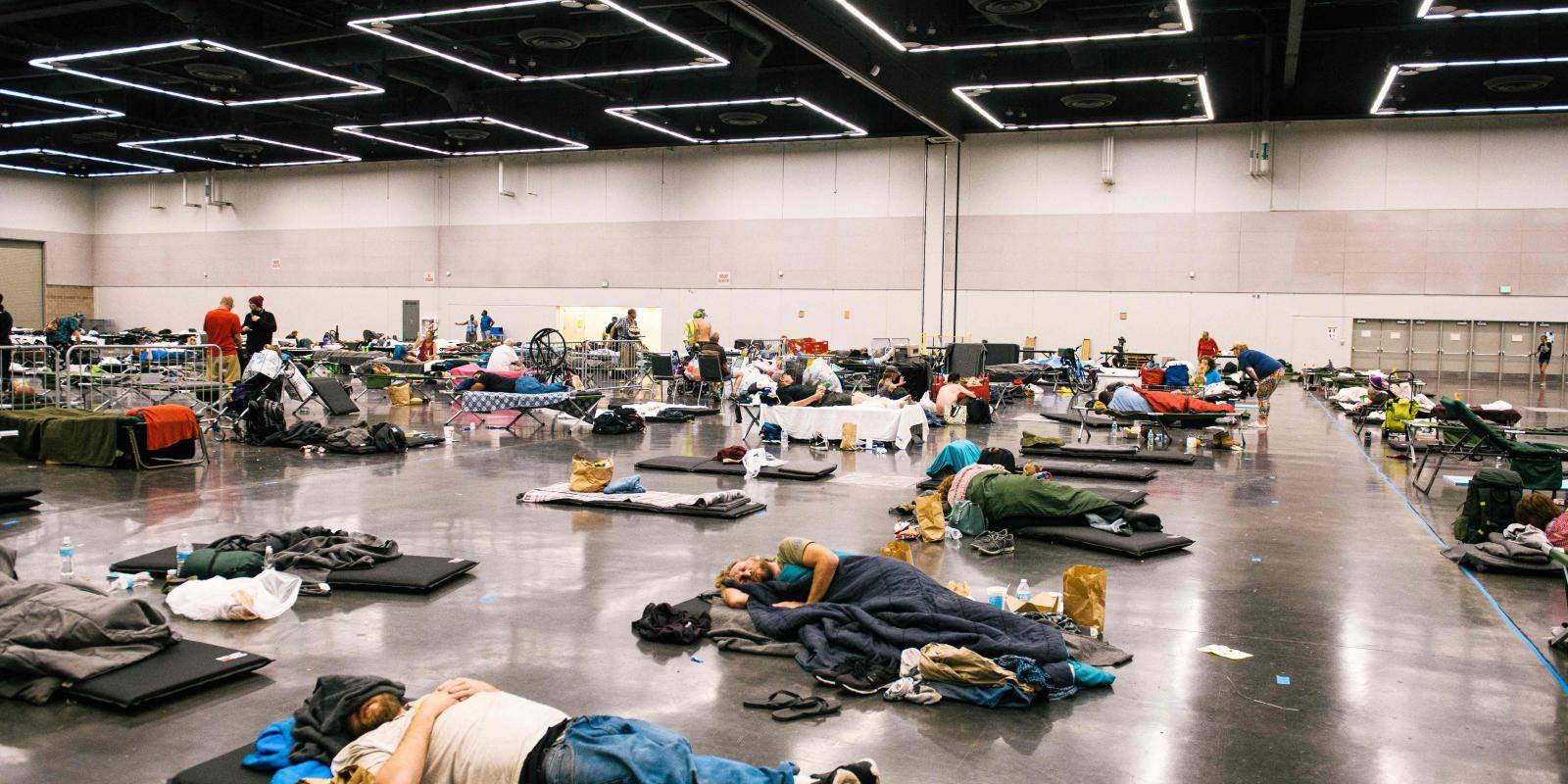 Photo shows people lying down at a cooling station during a heatwave in Portland, Oregon, in June 2021