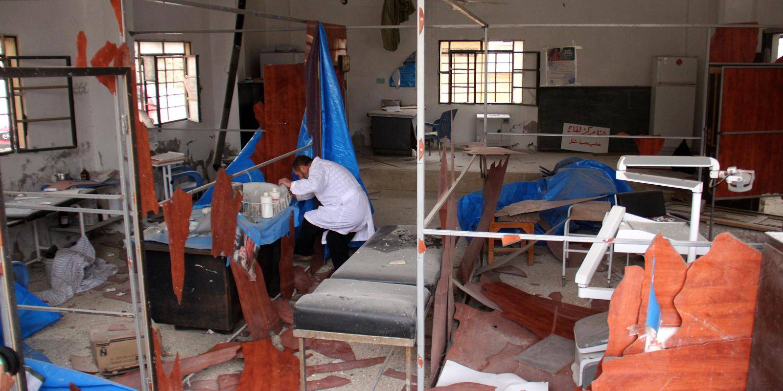 A man checks damage at a medical clinic following government air strikes on Binnish, in Syria’s Idlib governorate, December 2016.