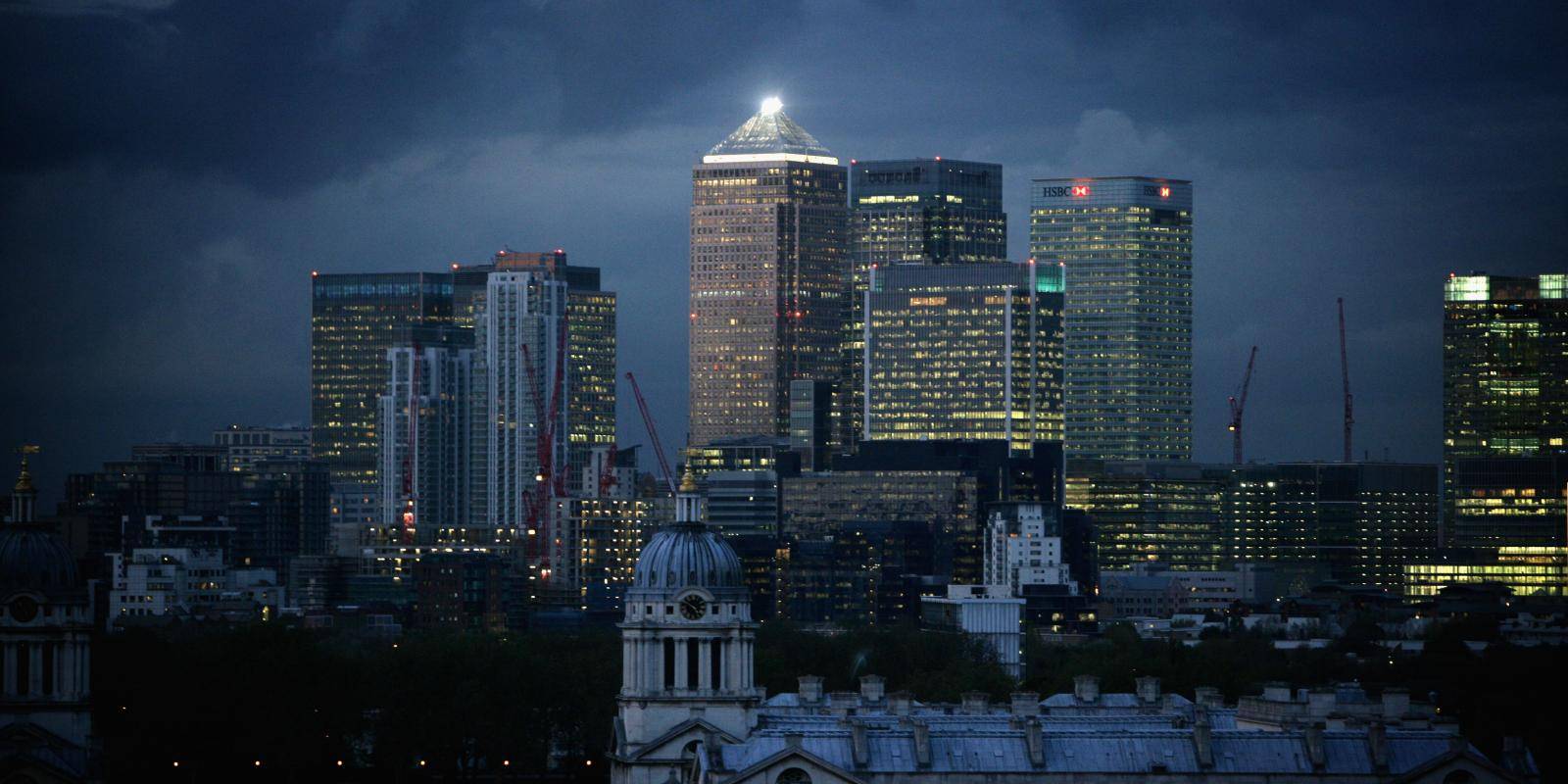 Dark clouds gather over the Canary Wharf business district of London, UK