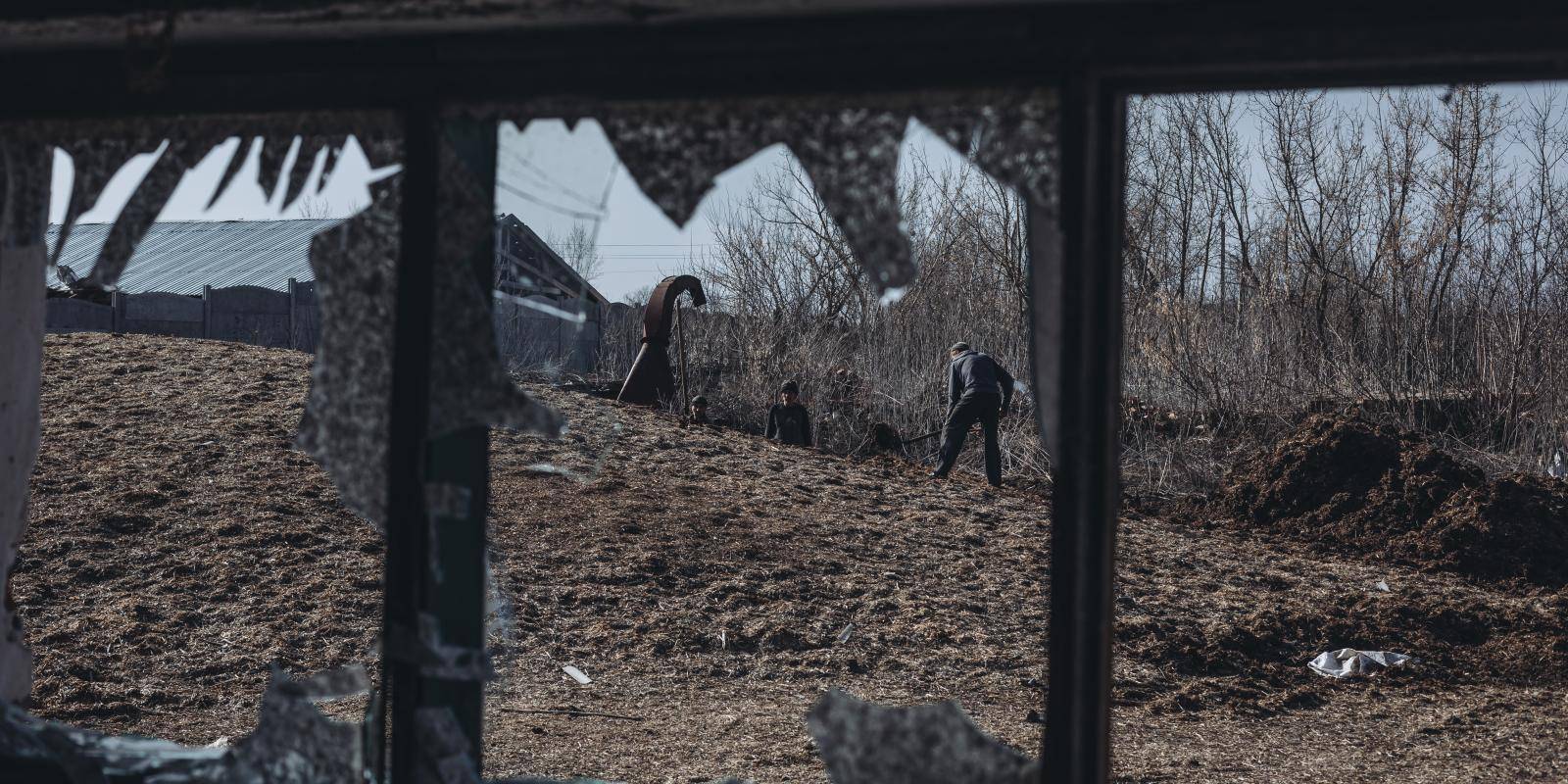 Farmers work on a bombed farm outside Kharkiv, Ukraine.