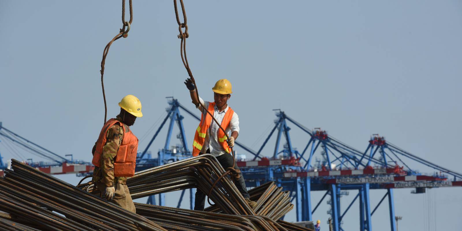 Chinese and Ivorian technicians working on the construction of a new container terminal at the port of Abidjan, in Côte d'Ivoire.