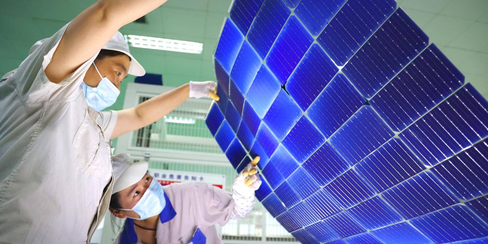 Women working in a Chinese factory producing solar panels.