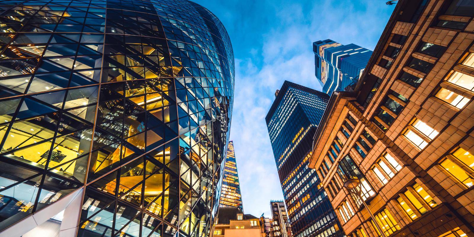 Looking directly up at the skyline of the financial district in central London.