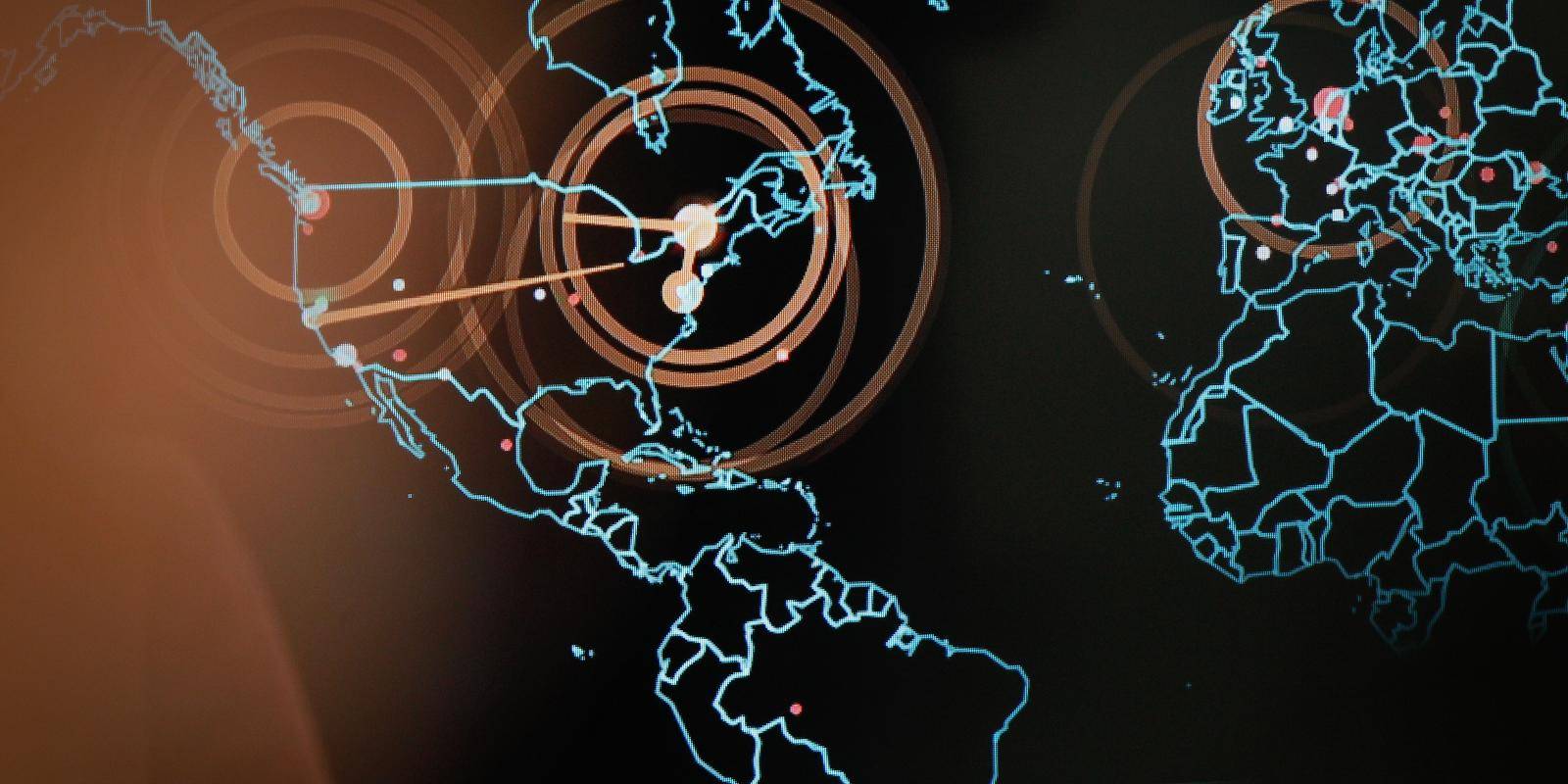 A large screen with outline map of the world depicting a simulated cyberattack