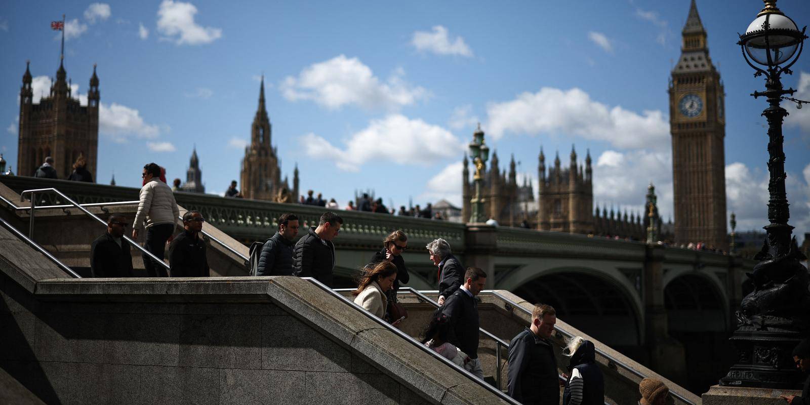 Photo of pedestrians opposite the Houses of Parliament, London, April 2024.