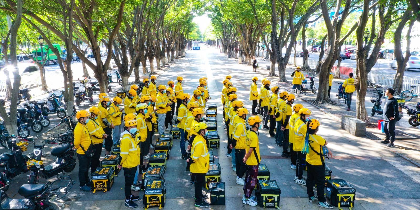 Delivery drivers attend a meeting on a street in Guangdong province, China.