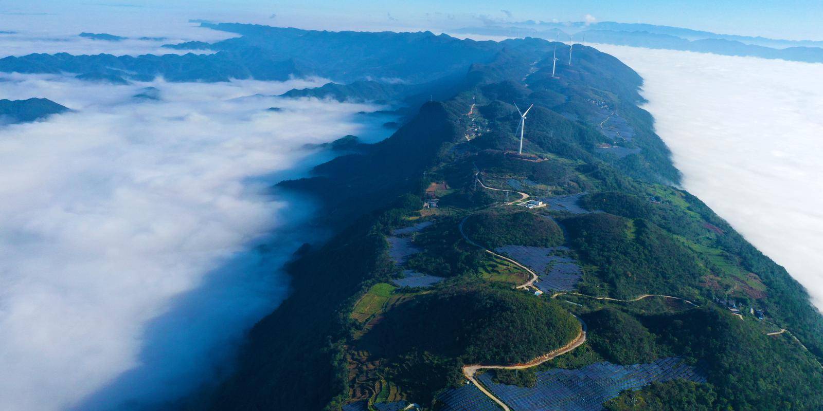 Wind turbines and solar panels running high across a mountain in Chongqing, China