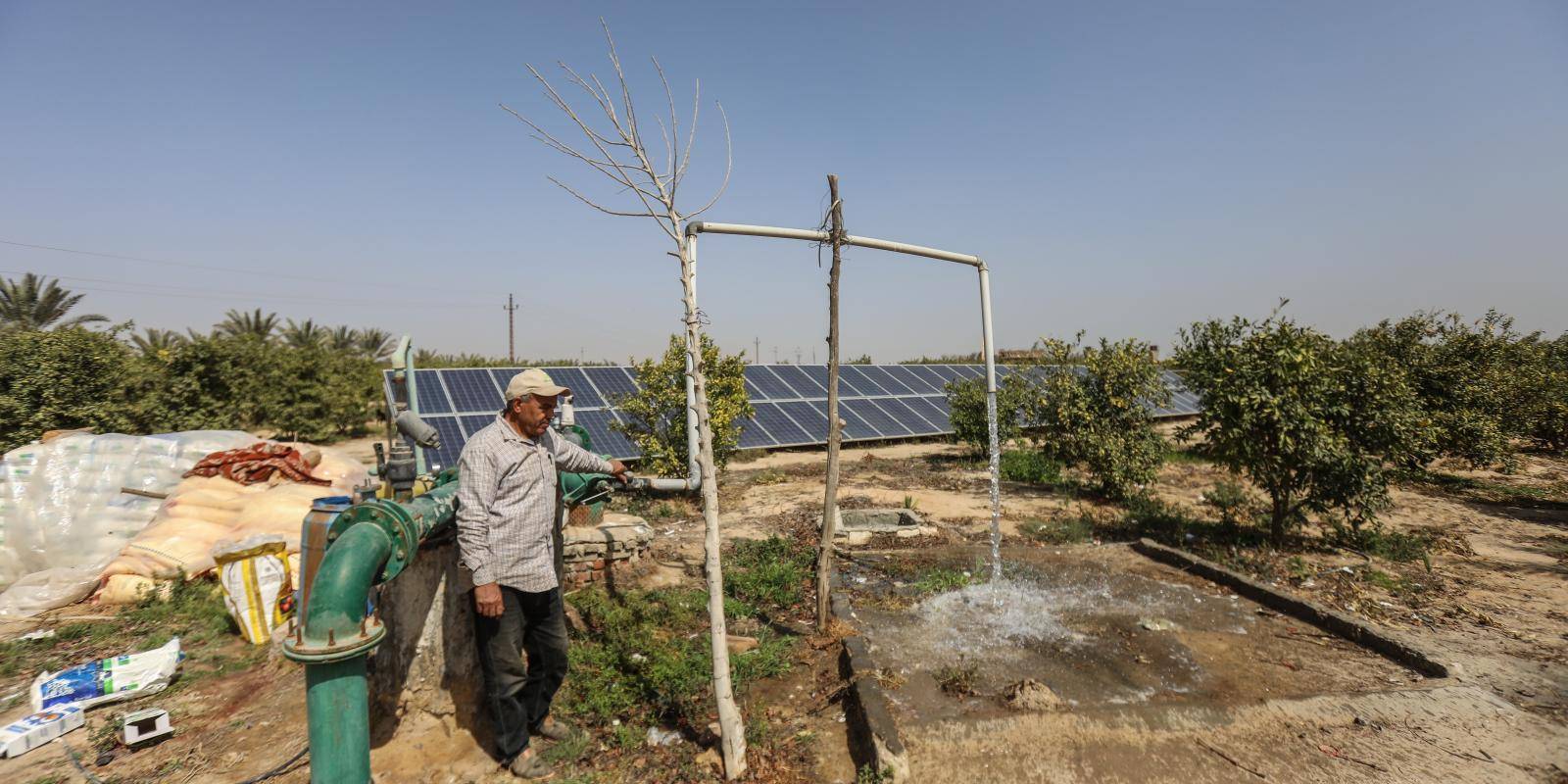 An Egyptian farmer looks at his solar power equipment.
