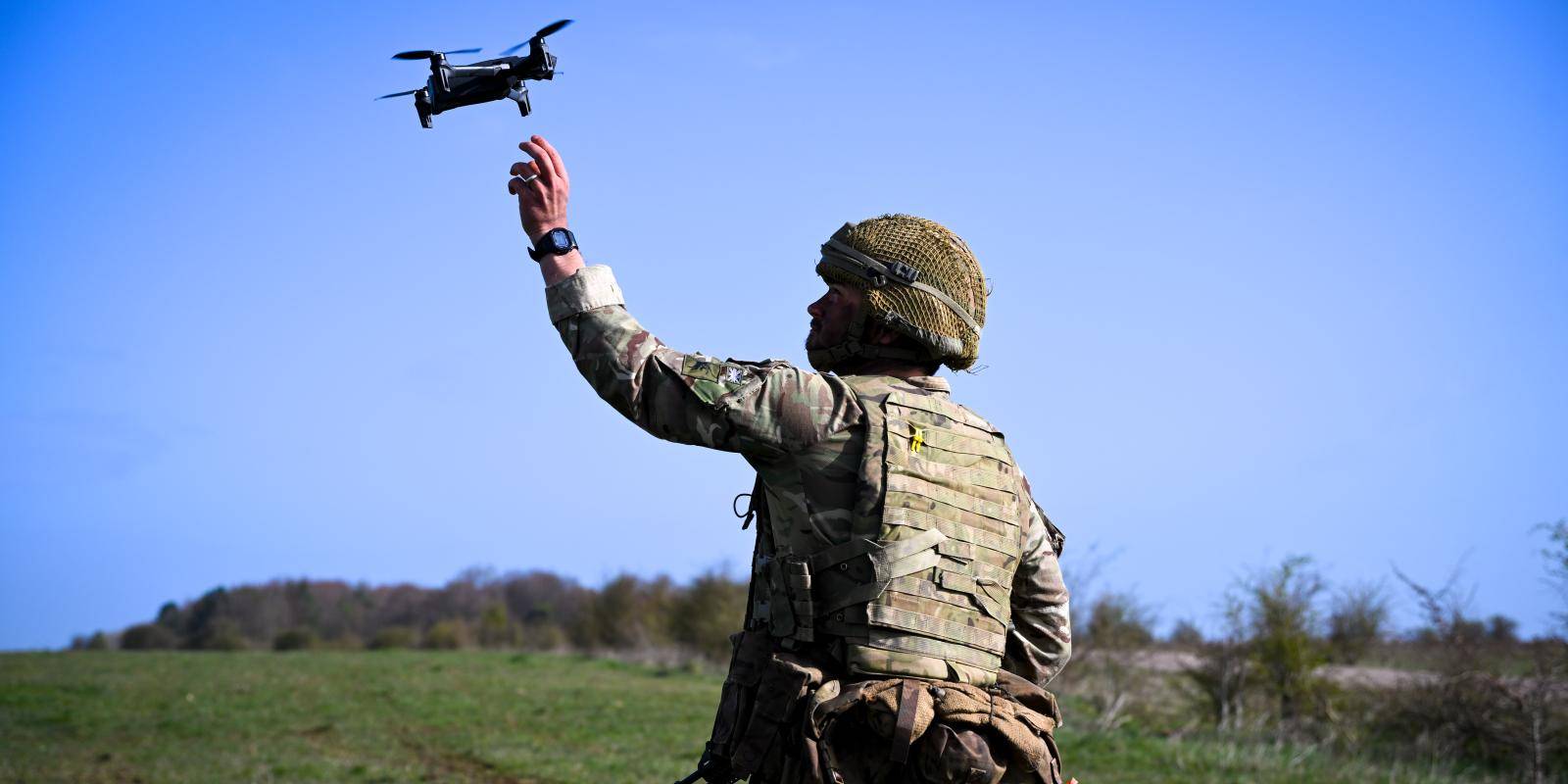 Image of a soldier flying a small drone