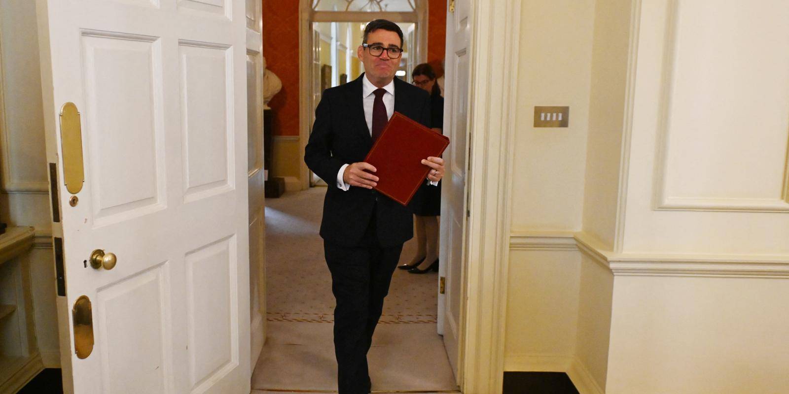 Photo of Andy Burnham walking to chair a cabinet meeting