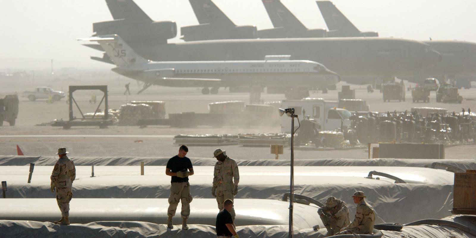 Members of the Petroleum Oils and Lubricants (POL) squadron at the 379th Air Expeditionary Wing take a break from replacing a 50,000-gallon fuel bladder in support of Operation Enduring Freedom December 30, 2002 in Al Udeid, Qatar.