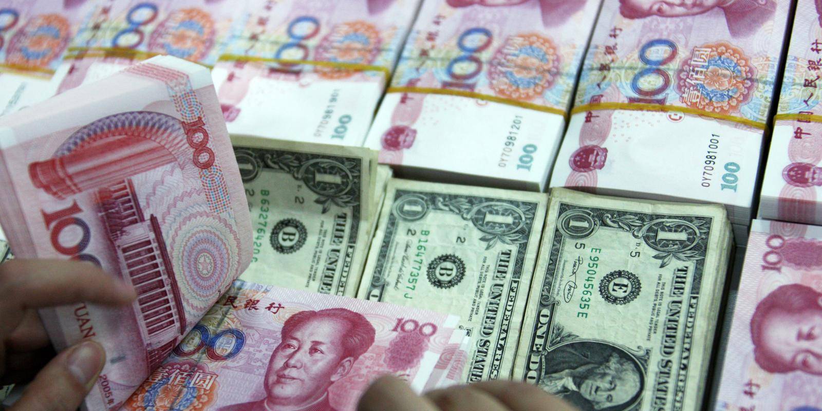 An employee counts money at a branch of the Industrial and Commercial Bank of China, Anhui Province, 26 July 2011. Copyright © Visual China Group via Getty Images