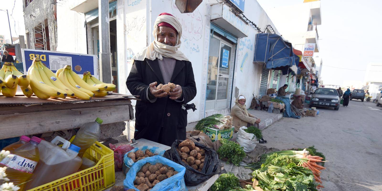 A Tunisian vendor poses as he sells white truffles at a market in the town of Ben Guerdane,40km west of the Libyan border, in February 2016.