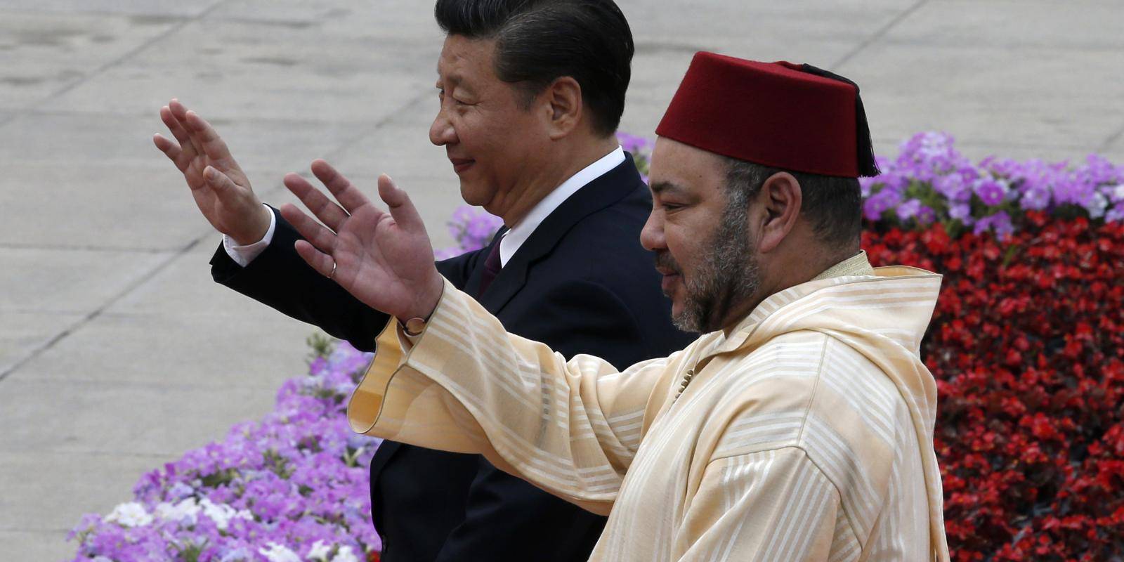 Chinese President Xi Jinping and King Mohammed VI of Morocco wave during a welcoming ceremony outside the Great Hall of the People in Beijing on 11 May 2016.