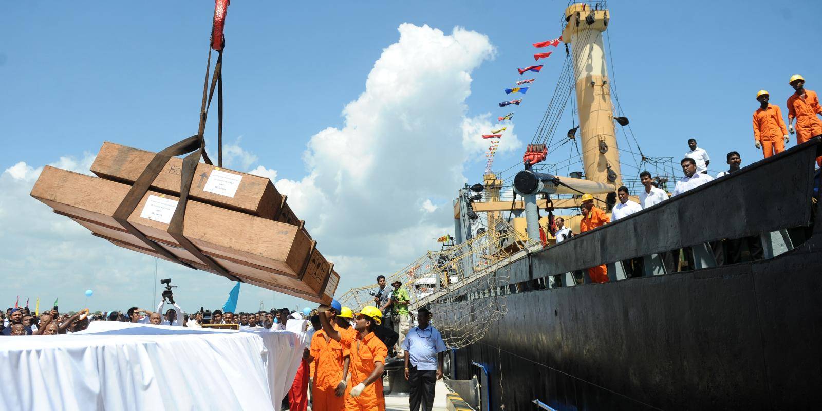 Workers unload cargo from the first vessel to enter the newly built Chinese-funded
port in Hambantota, 18 November 2010. Photo: Getty Images.