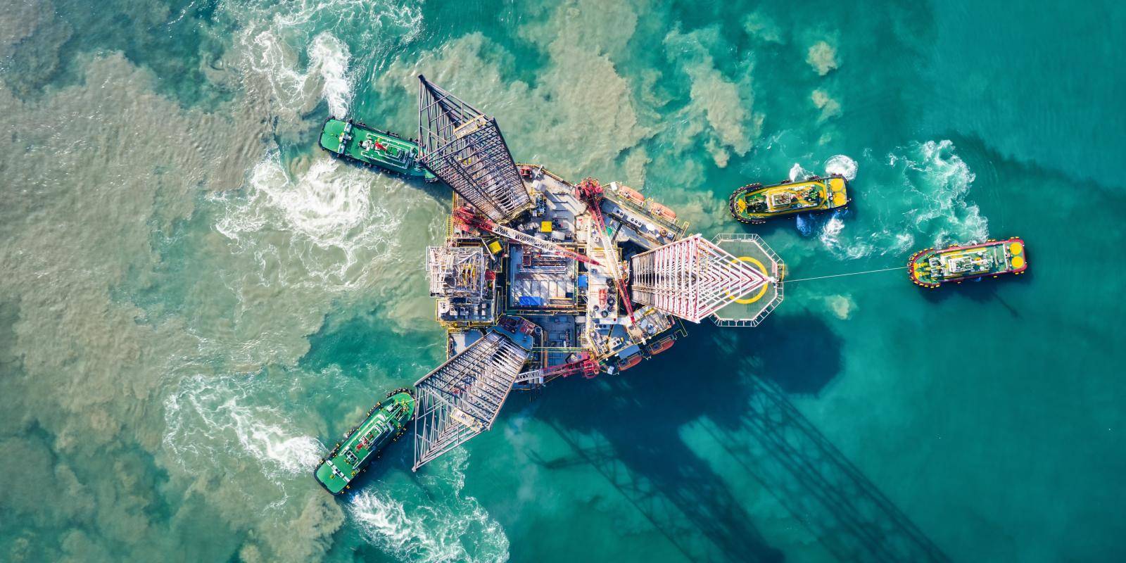 Supply boats towing an oil drilling rig, São Tomé and Príncipe. Photo: Getty Images.