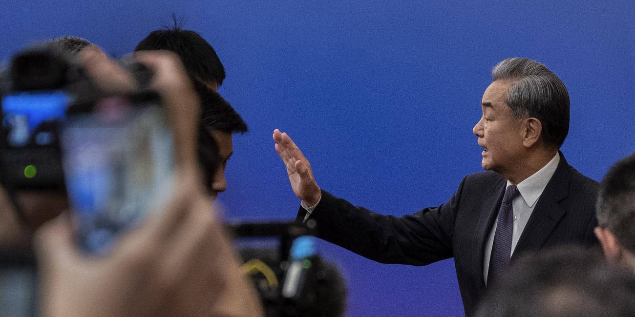 Chinese Foreign Minister Wang Yi gesturing during a press conference.