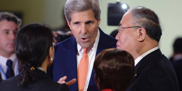 US Secretary of State John Kerry speaks with China's Special Representative on Climate Change Xie Zhenhua and delegates at the COP21 Climate Conference in France.