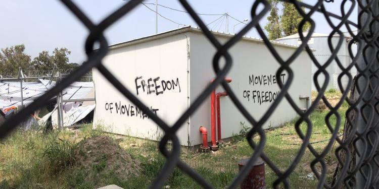 Photo of a house with graffiti saying 'Freedom of movement' in Moria refugee camp on Lesvos. Photo by Anna Iasmi Vallianatou