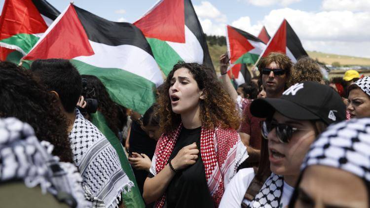 Palestinian and Arab Israeli protesters march for the right of return for refugees who fled their homes or were expelled during the 1948 war. Photo by AHMAD GHARABLI/AFP via Getty Images.