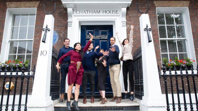 Academy fellows from the 2020 cohort in front of the iconic Chatham House blue door.