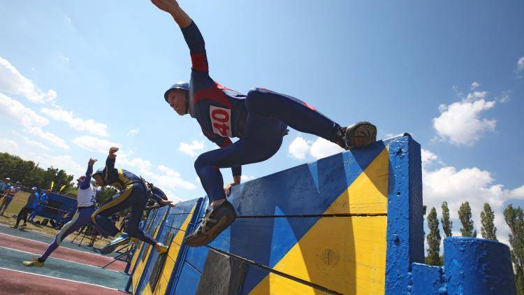 Competitors during the 27th Ukrainian Firefighting Championship in Kharkiv, northeastern Ukraine on 3 July 2019. Inter-communal cooperation introduced as part of Ukraine's decentralization drive has included the fire services, education and healthcare. Photo: Getty Images.