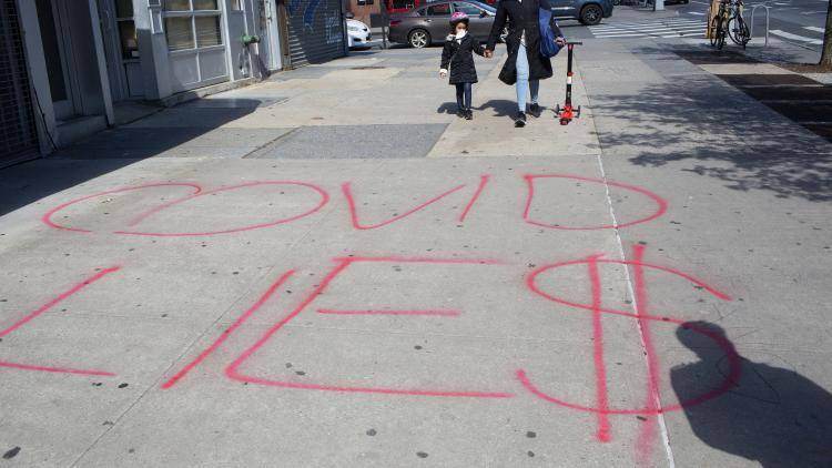 Conspiracy theorists’ graffiti on a pavement in Brooklyn, New York.
