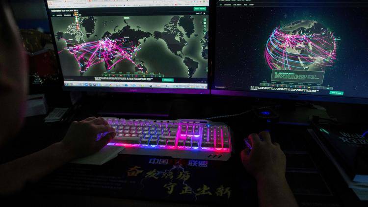 Hacking group Red Hacker Alliance use website monitoring global cyberattacks in Dongguan, China. Photo by NICOLAS ASFOURI / AFP.