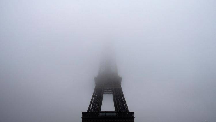 The Eiffel Tower half-covered with smog