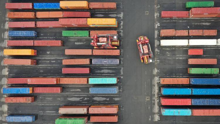 An aerial photo shows Straddle Carriers moving shipping containers at Seaforth Dock in Liverpool, north west England on 17 March 2021. Photo by PAUL ELLIS/AFP via Getty Images.