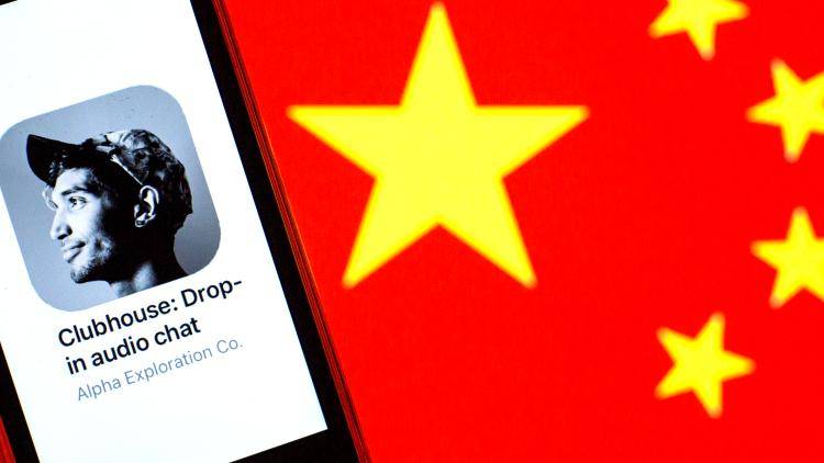 A Chinese flag alongside a phone featuring the podcast app called Clubhouse 
