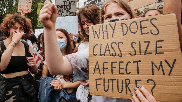 A crowd protests education policies in the UK