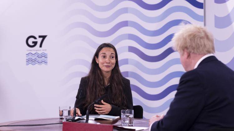 Sophie Daud and Boris Johnson sitting at a table for an interview