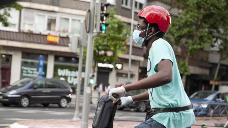 A teenager riding an electric scooter