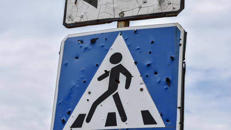 A damaged pedestrian road sign in Krasnohorivka, in the Donbas region of Ukraine.