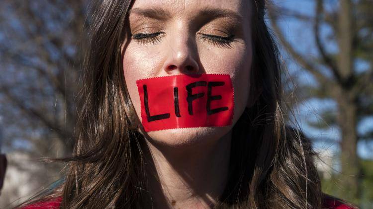 A pro-life activist participates in a rally outside of the Supreme Court