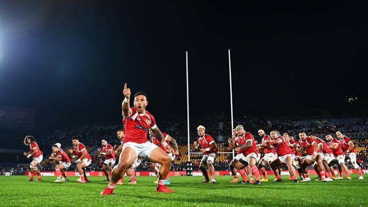 The Tongan rugby team perform a chant on a rugby pitch before an international match