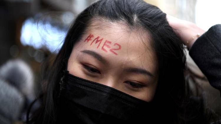 Protester with a #Me2 written on her face
