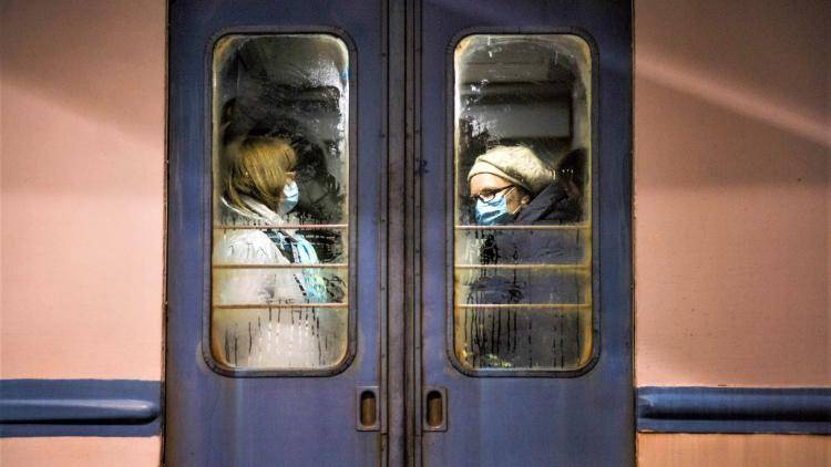 Two Ukrainian women can be seen through the window of a train that has arrived from Ukraine to Przemysl train station in Poland on 3 March 2022. Thousands of refugees have been fleeing war to the Polish border town of Przemysl. Photo: Attila Husejnow/SOPA Images/LightRocket via Getty Images.