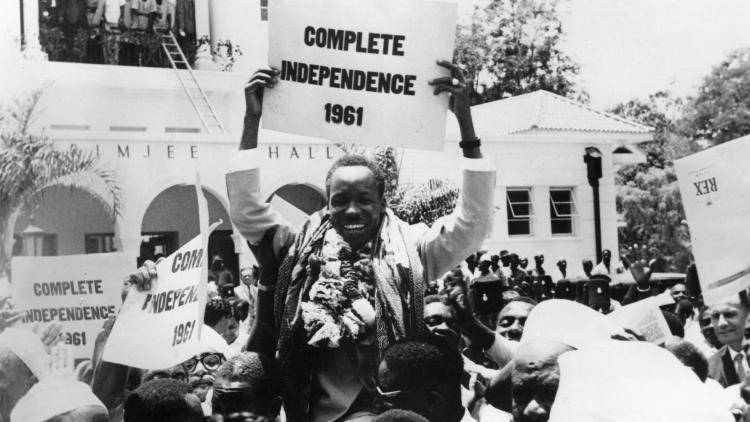 A black and white photo of a jubilant crowd carries Julius Nyerere, premier of Tanganyika (Tanzania), after being granted internal self-government.
