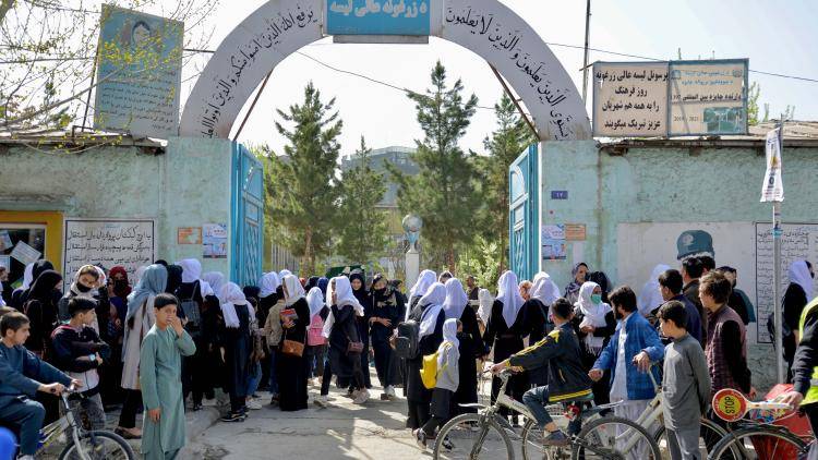 Girls leave their school following a Taliban order of closure just hours after reopening in Kabul on March 23, 2022.