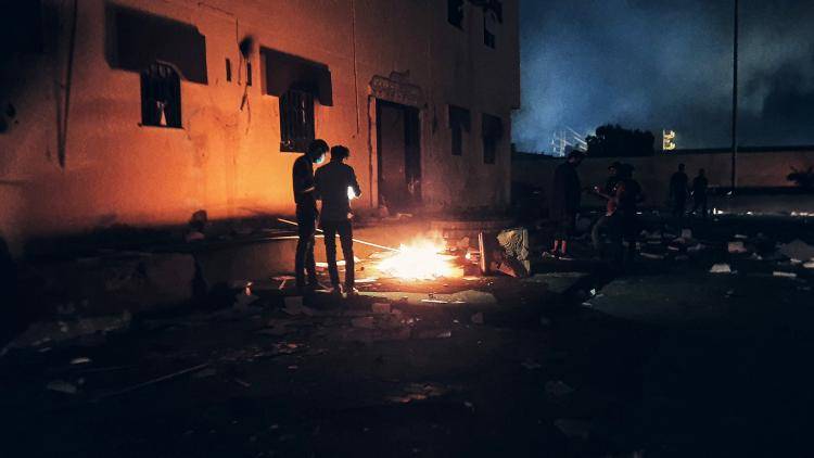 A Libyan parliament building in Tobruk is lit up by protesters who broke inside while demonstrating against deteriorating living conditions and political deadlock.
