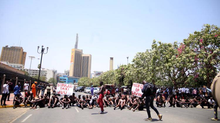 A group of people gather in front of the parliament building to protest against cost of living, high tax rates, and poor living conditions on 21 February 2023 in Nairobi, Kenya.