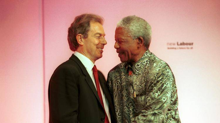 Tony Blair and Nelson Mandela embracing at the 2000 Labour party conference