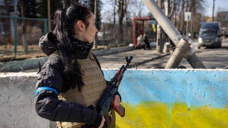 A volunteer takes position at a checkpoint in the Ukrainian capital, Kyiv.